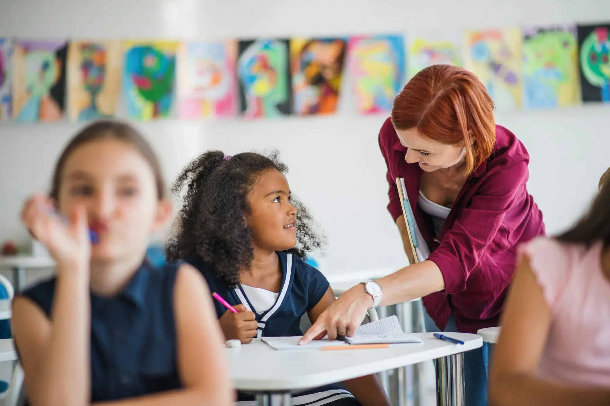 A teacher helping an elementary school student