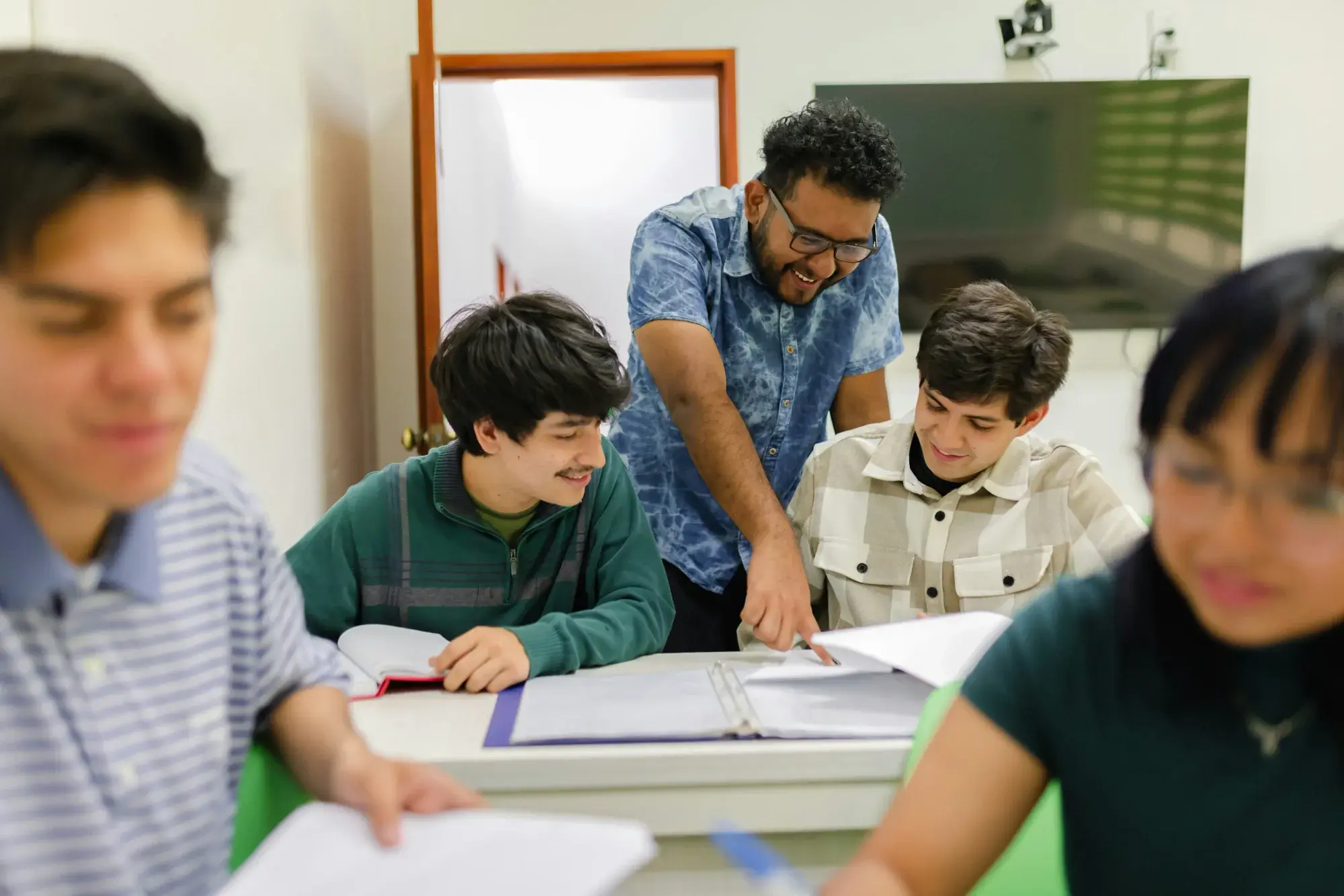 A teacher helping students with their schoolwork